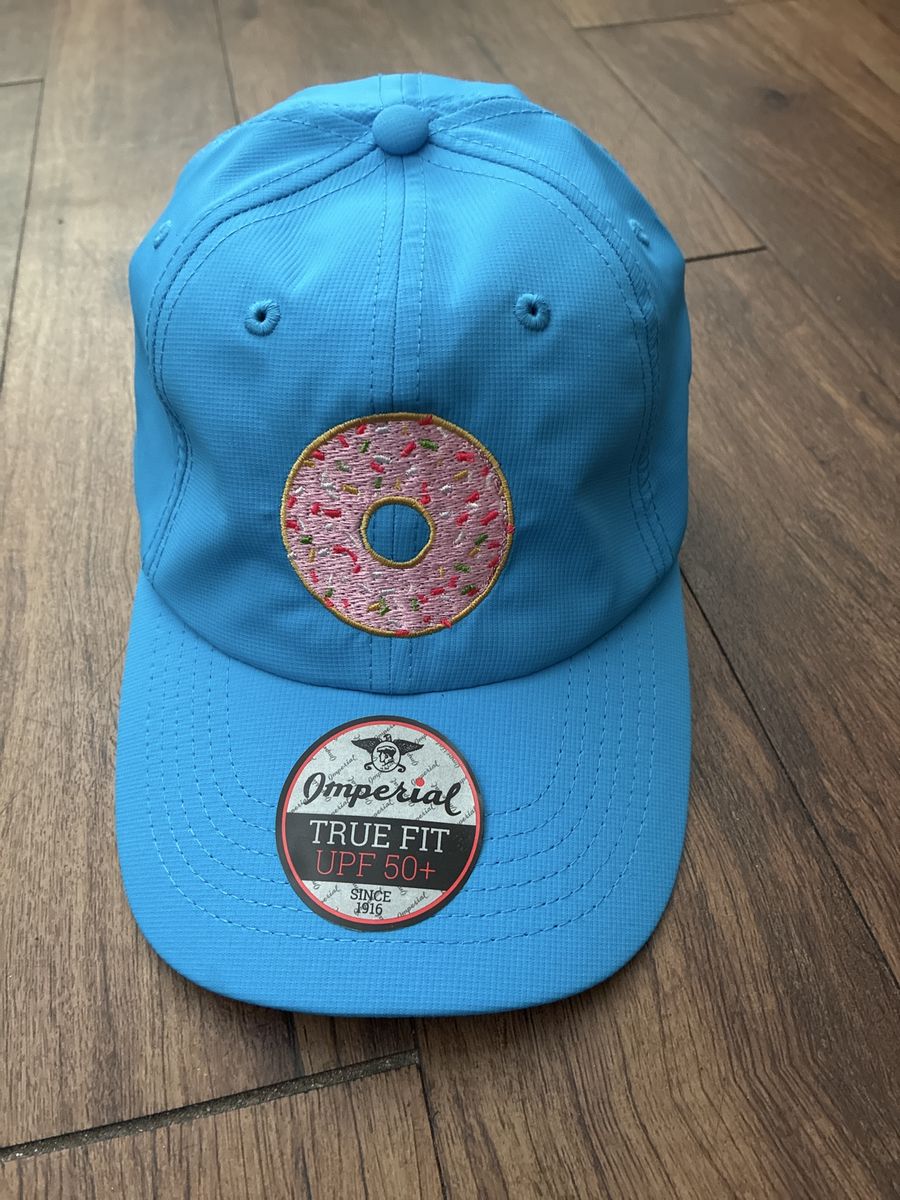 Sell or trade NEW golf hat with a pink donut embroidered blue adjustable