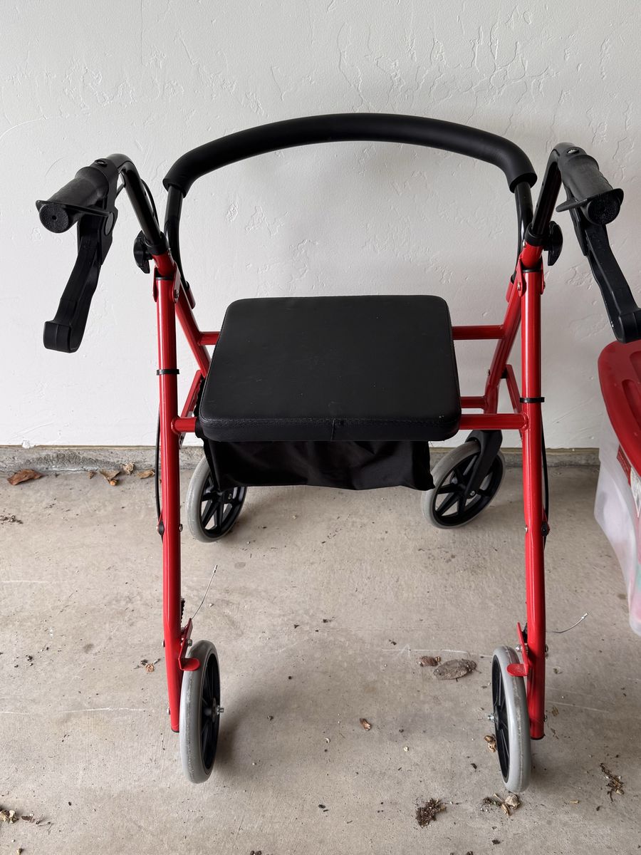 Red Four-Wheel Rollator Walker with Padded Seat and Storage Bag
