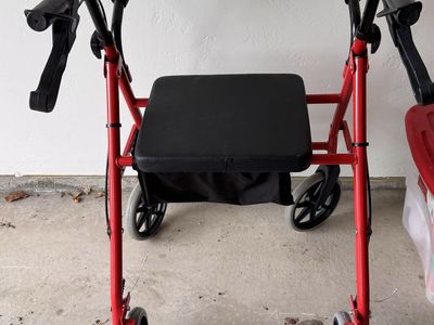 Red Four-Wheel Rollator Walker with Padded Seat and Storage Bag