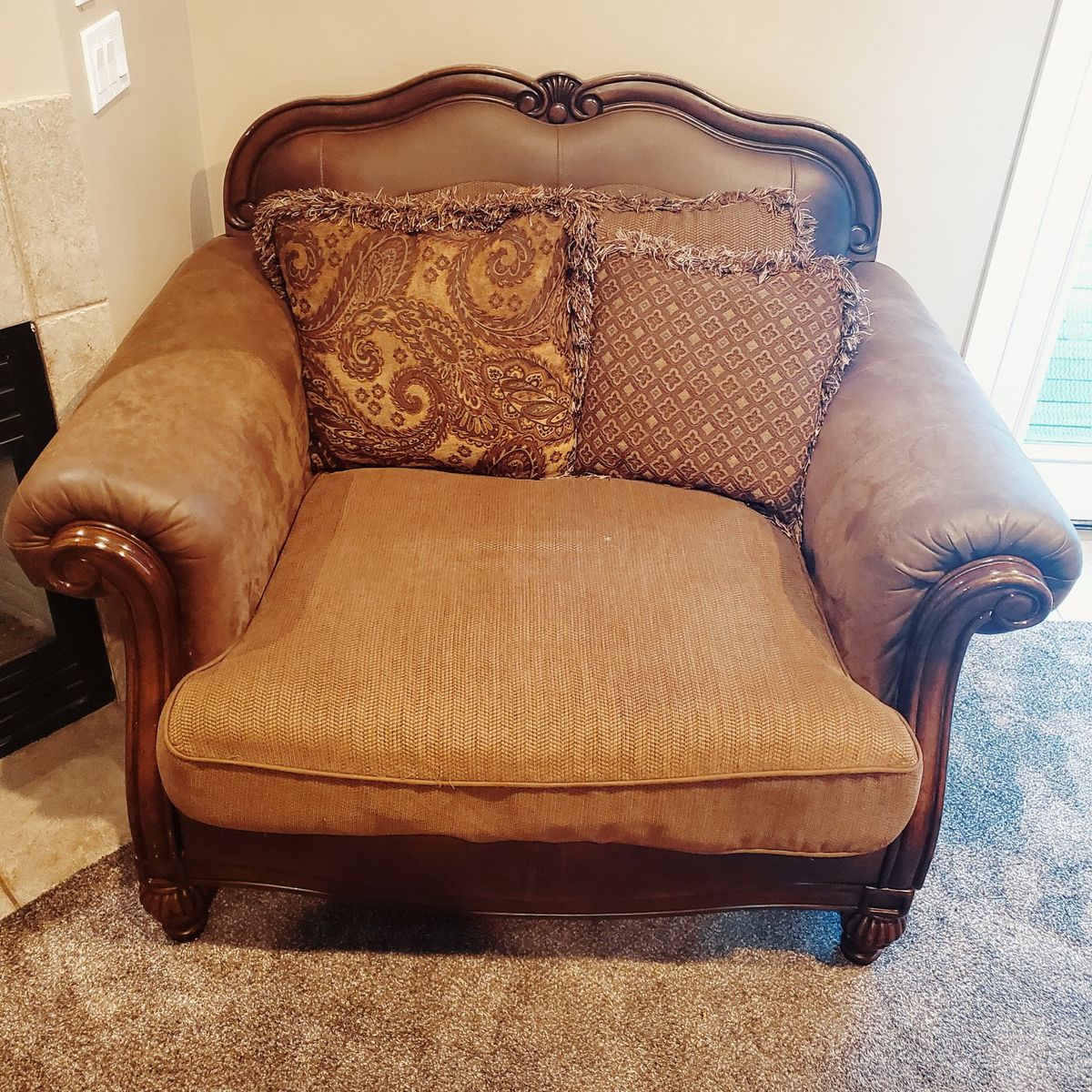 Ornate Brown Armchair with Decorative Pillows