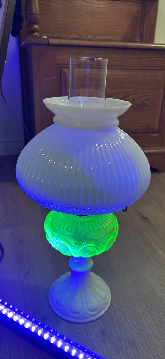 Vintage  Aladdin brand oil lamp featuring a "Washington Drape" pattern base made of uranium glass.