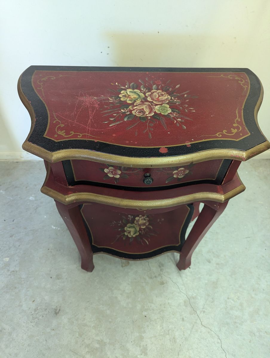 Vintage red and black hand-painted two-tier accent table with floral motifs and gold detailing