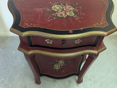 Vintage red and black hand-painted two-tier accent table with floral motifs and gold detailing