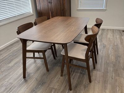 Walnut dining table with upholstered chairs