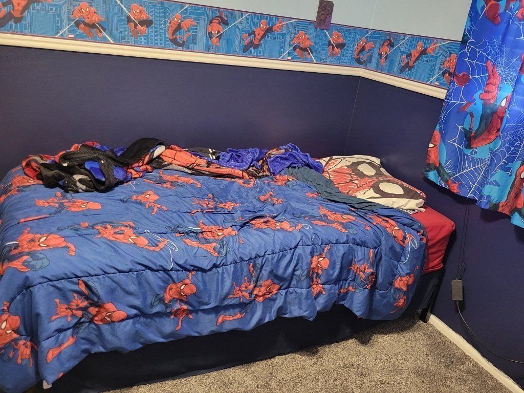 twin bed with frame, mattress Spiderman themed sheets and blanket