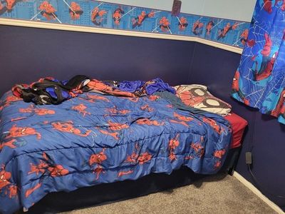 twin bed with frame, mattress Spiderman themed sheets and blanket