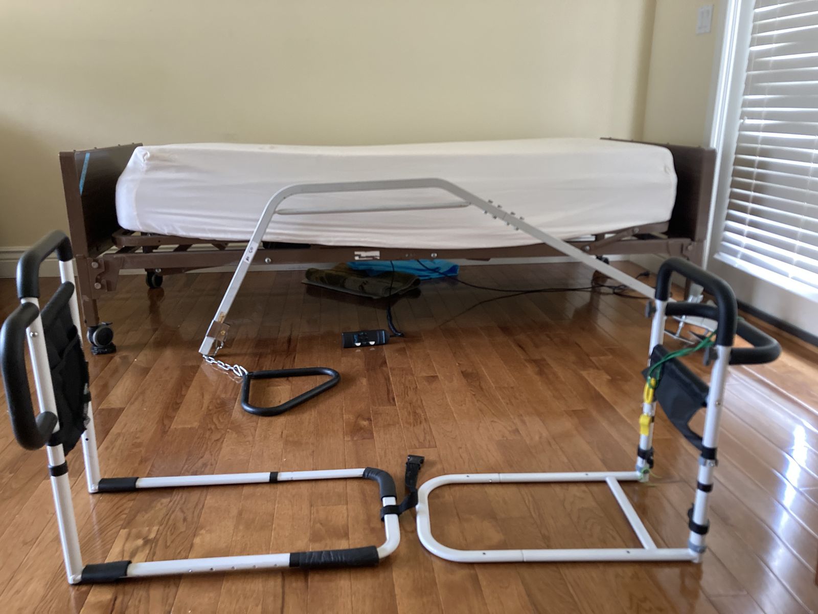 Hospital bed with side rails, mattress and trapeze bar