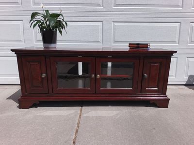 Cherry Finish Wood Entertainment Center TV Stand with Glass Doors and Storage. Delivery available