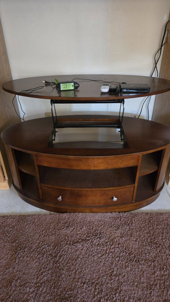 Oval design TV Table with height leveling system.