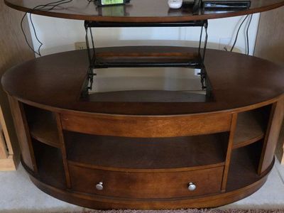 Oval design TV Table with height leveling system.