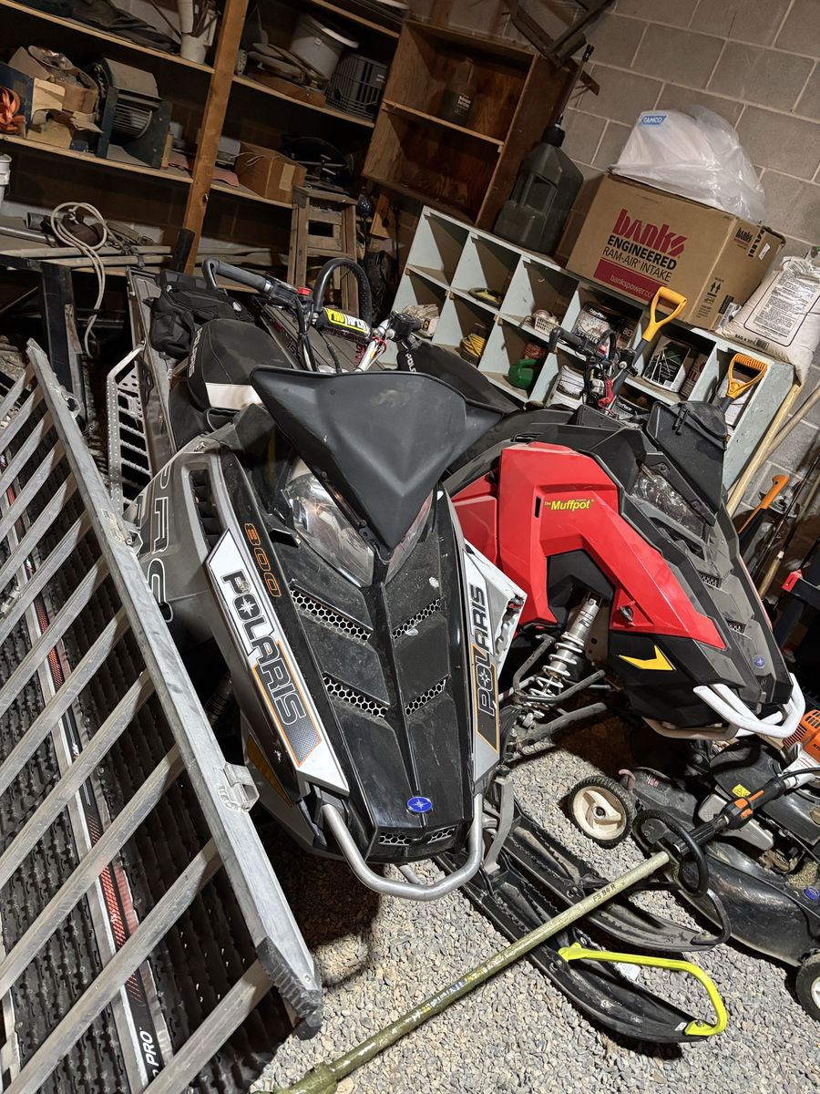 Two Polaris snowmobiles