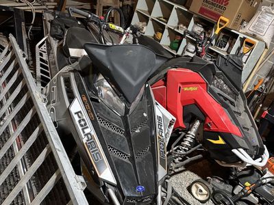 Two Polaris snowmobiles