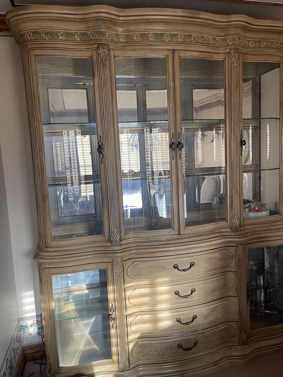 Elegant Light Wood China Cabinet & Buffet with Glass Shelves and Carved Details and matching table and 6 chairs.