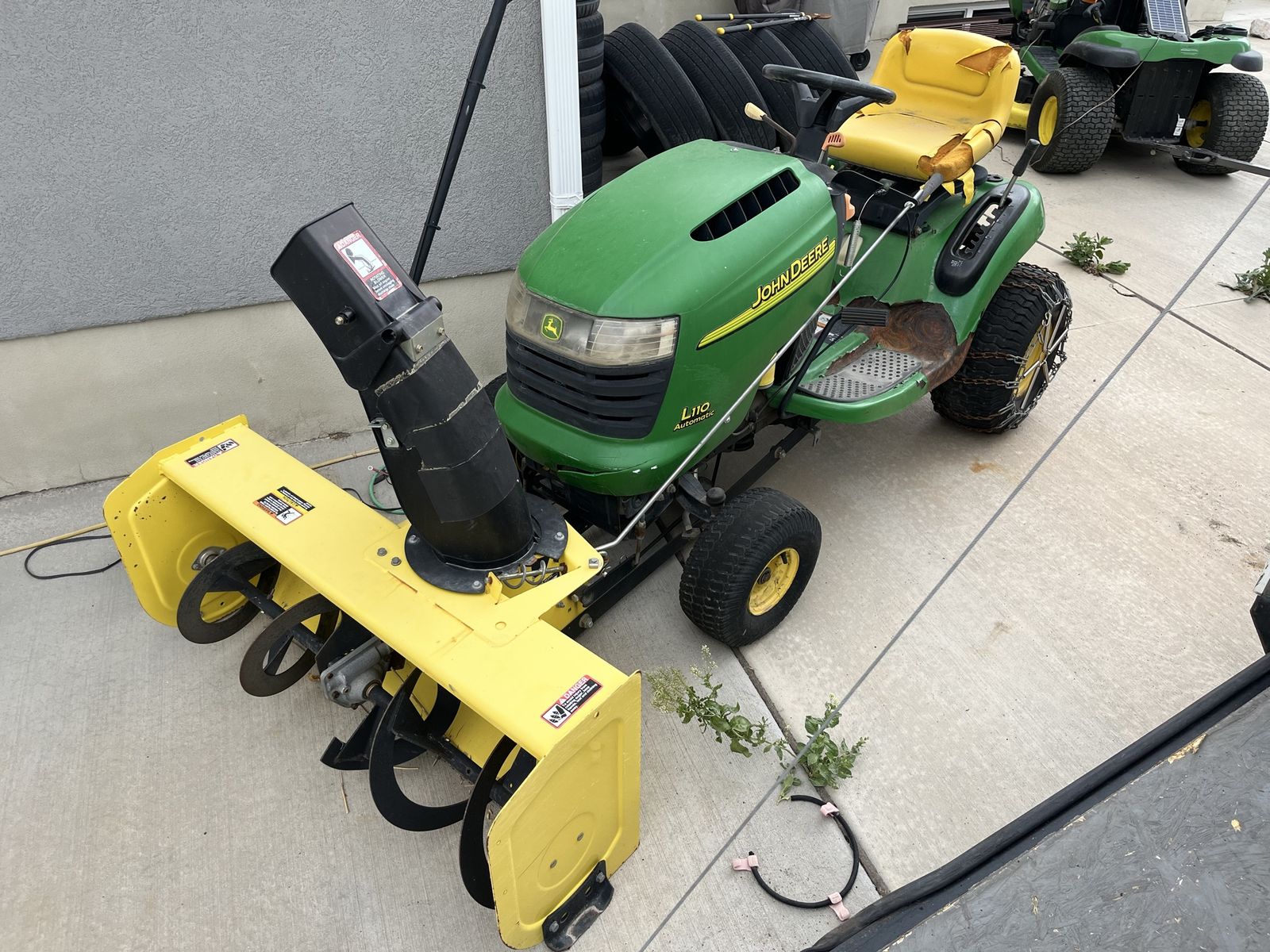 John Deere L110 Automatic Riding Lawn Mower with Snow Blower Attachment and Tire Chains