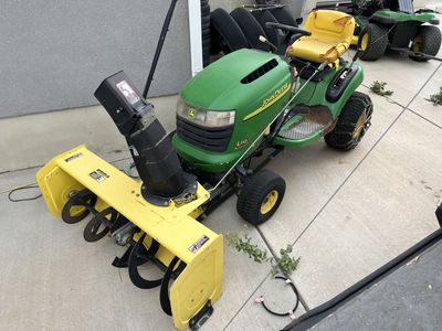 John Deere L110 Automatic Riding Lawn Mower with Snow Blower Attachment and Tire Chains
