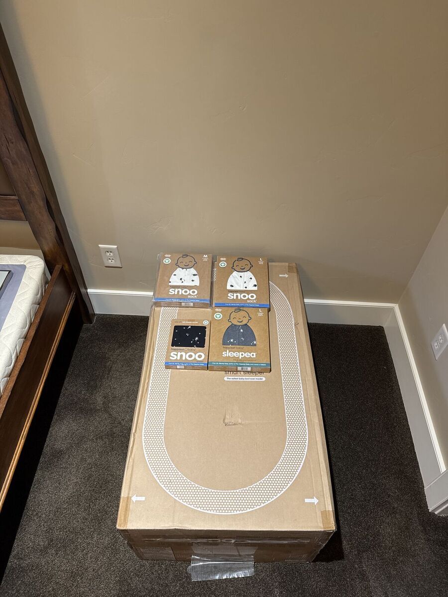New SNOO Smart Sleeper Bassinet with extra accessories by Happiest Baby with snoo sacks, sheet, and swaddle