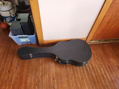 Quality hard case for an acoustic guitar. Hardish plastic, not just cardboard. Great shape.