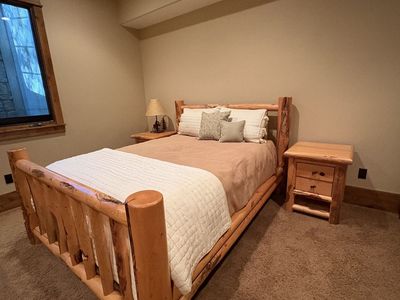 Solid wood queen bed frame with two end tables, queen mattress and box spring and bookshelf