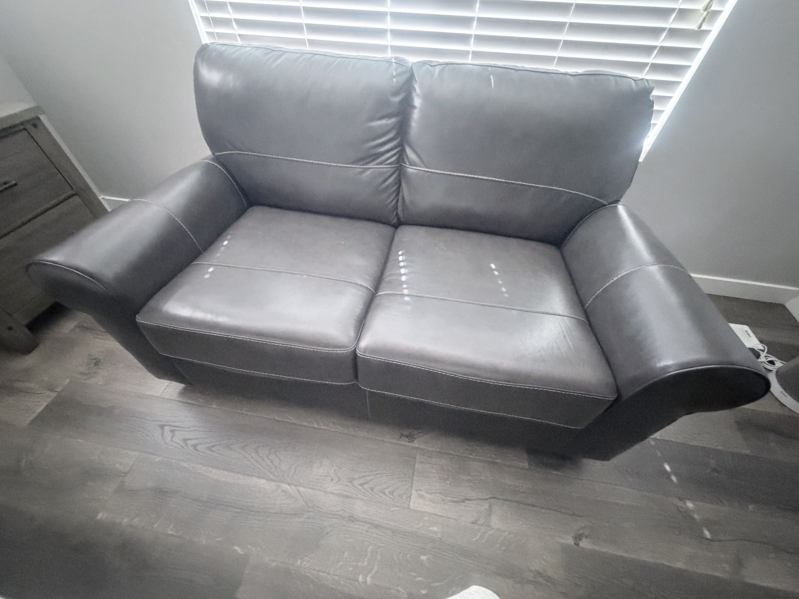 Grey leather loveseat