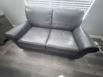 Grey leather loveseat