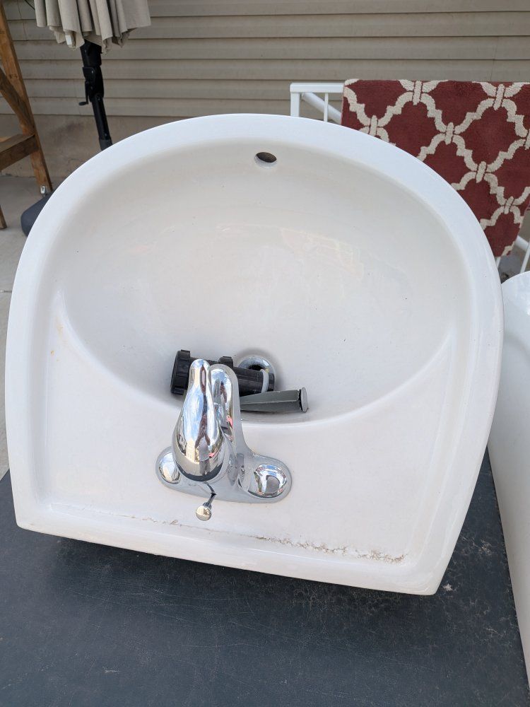White Ceramic Pedestal Sink with Chrome Faucet and Hardware