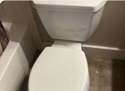 White elongated Kohler toilet with easy down lid