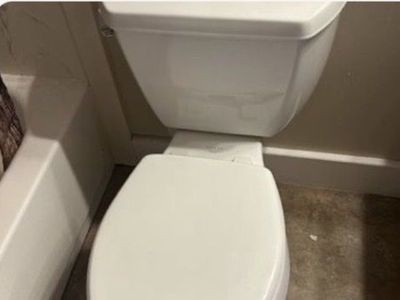 White elongated Kohler toilet with easy down lid