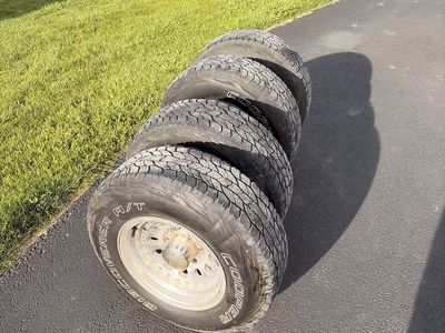Set of 4 Cooper Discoverer A/T Tires with Custom Silver Wheels & Center Caps