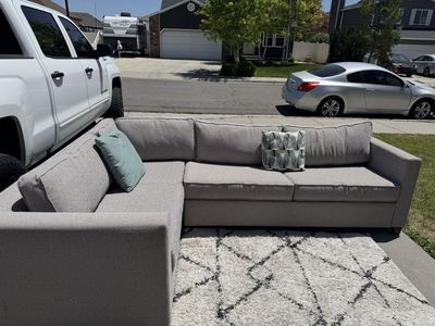 Gray Sectonial Couch And A Bed