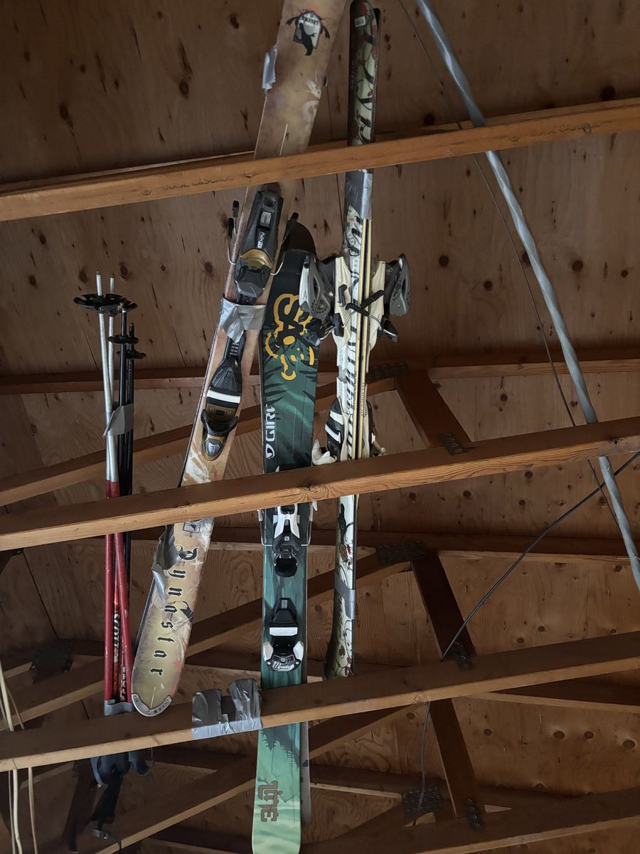 3 pairs of skiis, 2 sets of poles and 2 pairs of boots