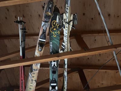 3 pairs of skiis, 2 sets of poles and 2 pairs of boots