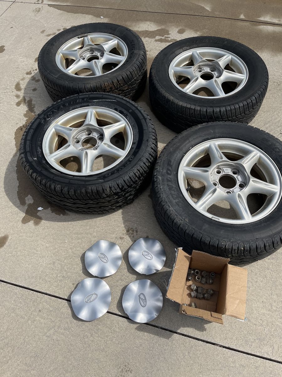 Full Set Of 215/60R-15 Dunlap Tires With Caps And Lug Nuts