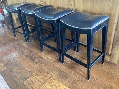 Four sturdy leather and wood barstools by Woodbridge furniture