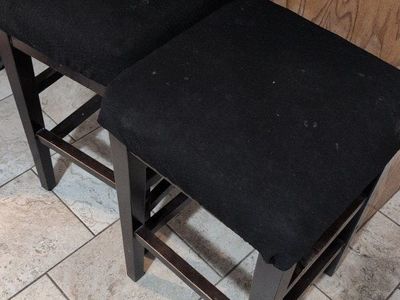 Four Dark Wood Counter Height Bar Stools.