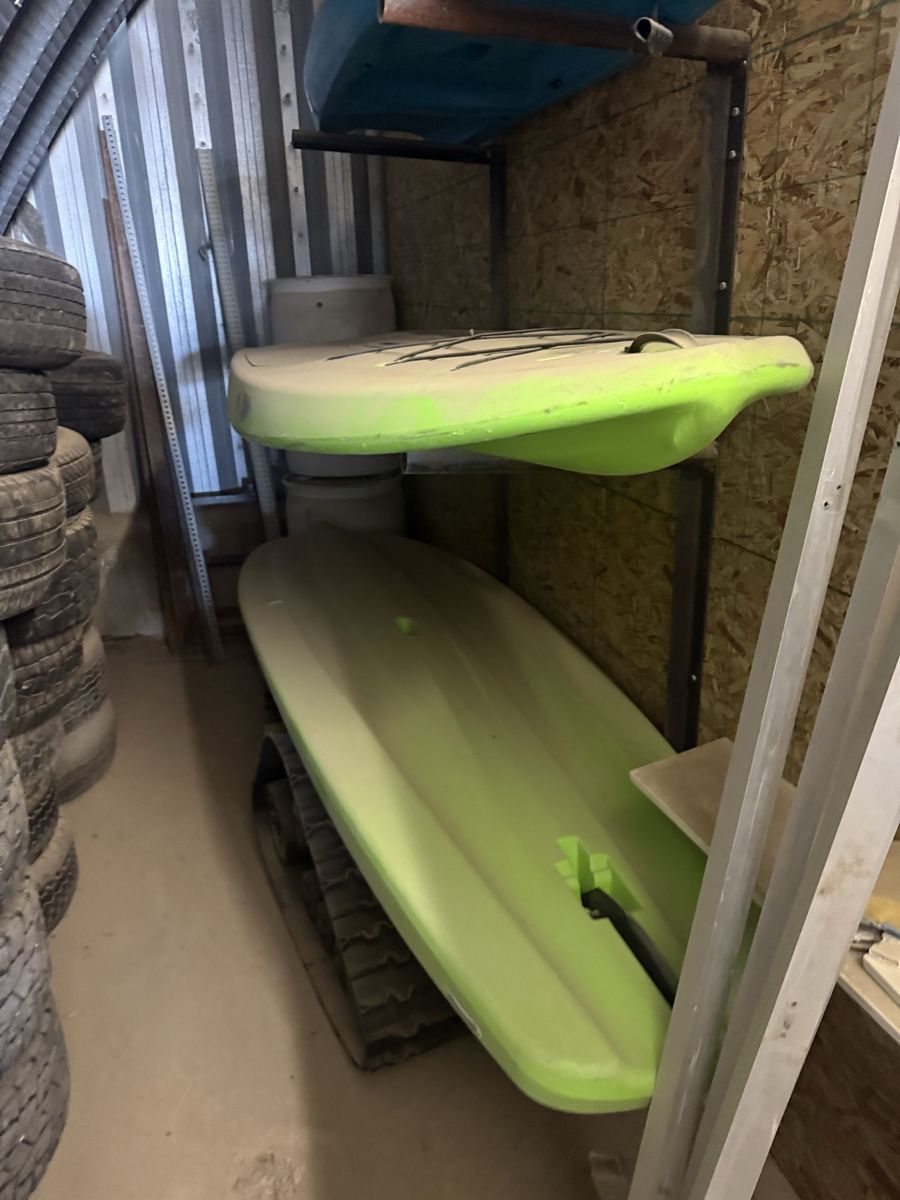 2 paddle boards and one small kayak