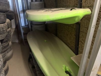 2 paddle boards and one small kayak
