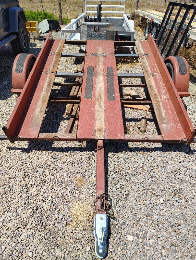 Red Utility Trailer - Flatbed, Single Axle and Spare Tire.