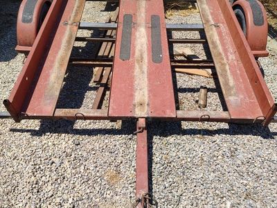 Red Utility Trailer - Flatbed, Single Axle and Spare Tire.