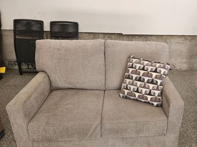 Cozy Brown Loveseat with Patterned Throw Pillow