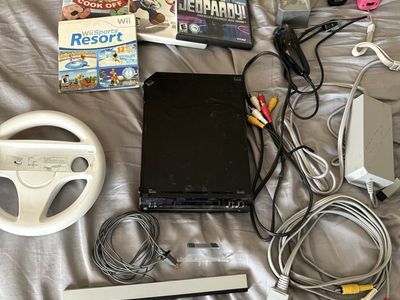 Nintendo Wii Console Bundle with 4 Games, 2 Remotes, Steering Wheel, and Accessories - Used