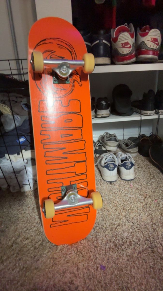 Orange Skateboard with Graphic Bottom and Grip Tape