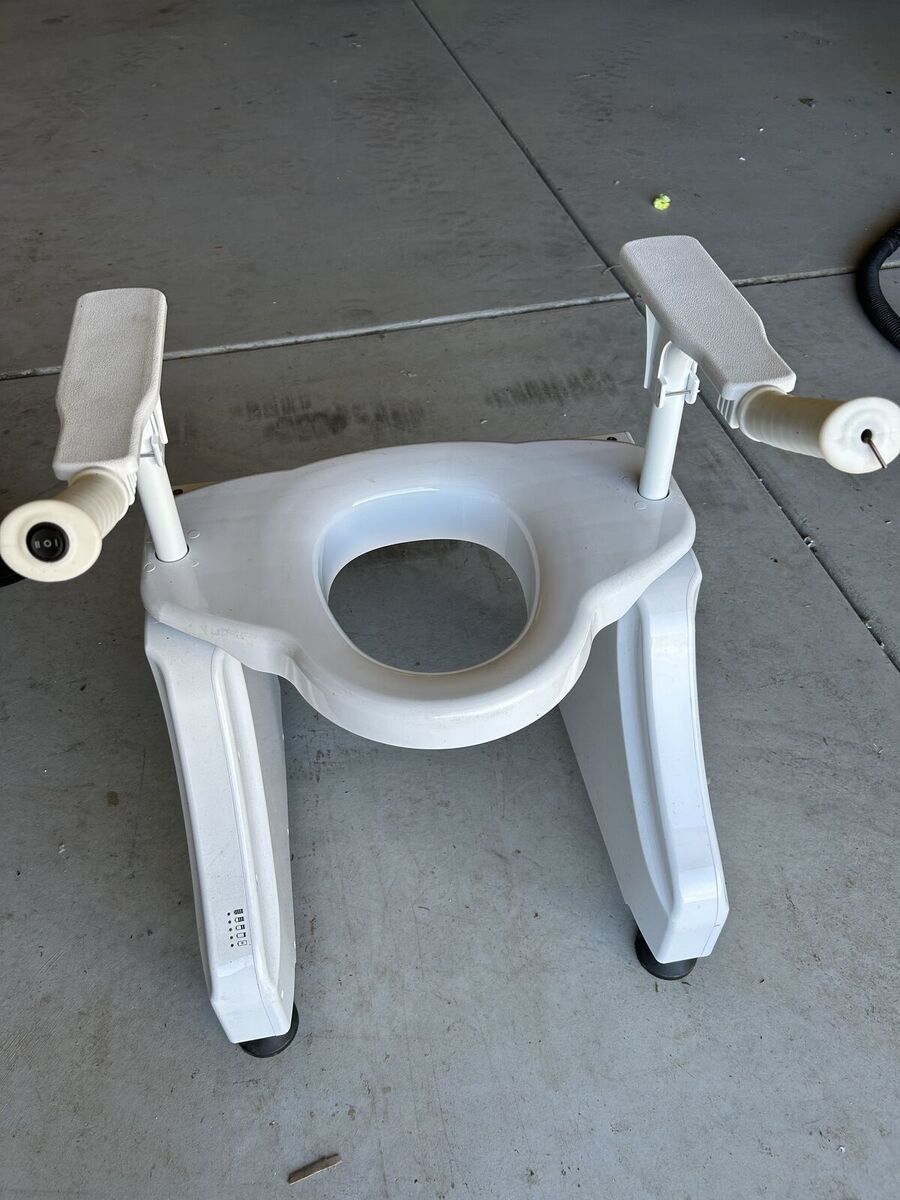 Powered stand up toilet seat