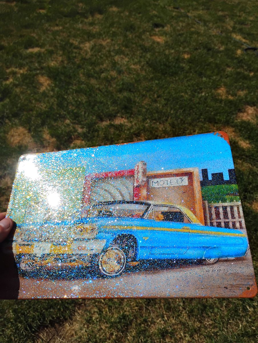 Custom painted gold and blue metal flake lowrider Impala tin signs.