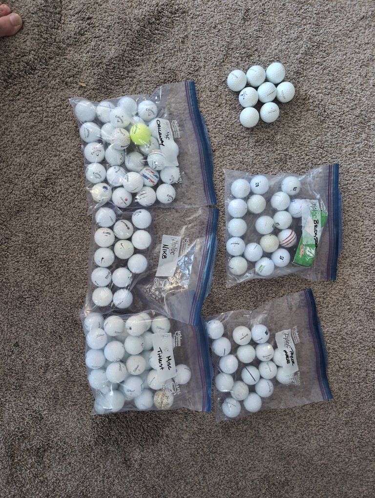 Assorted found golf balls sorted by brand.