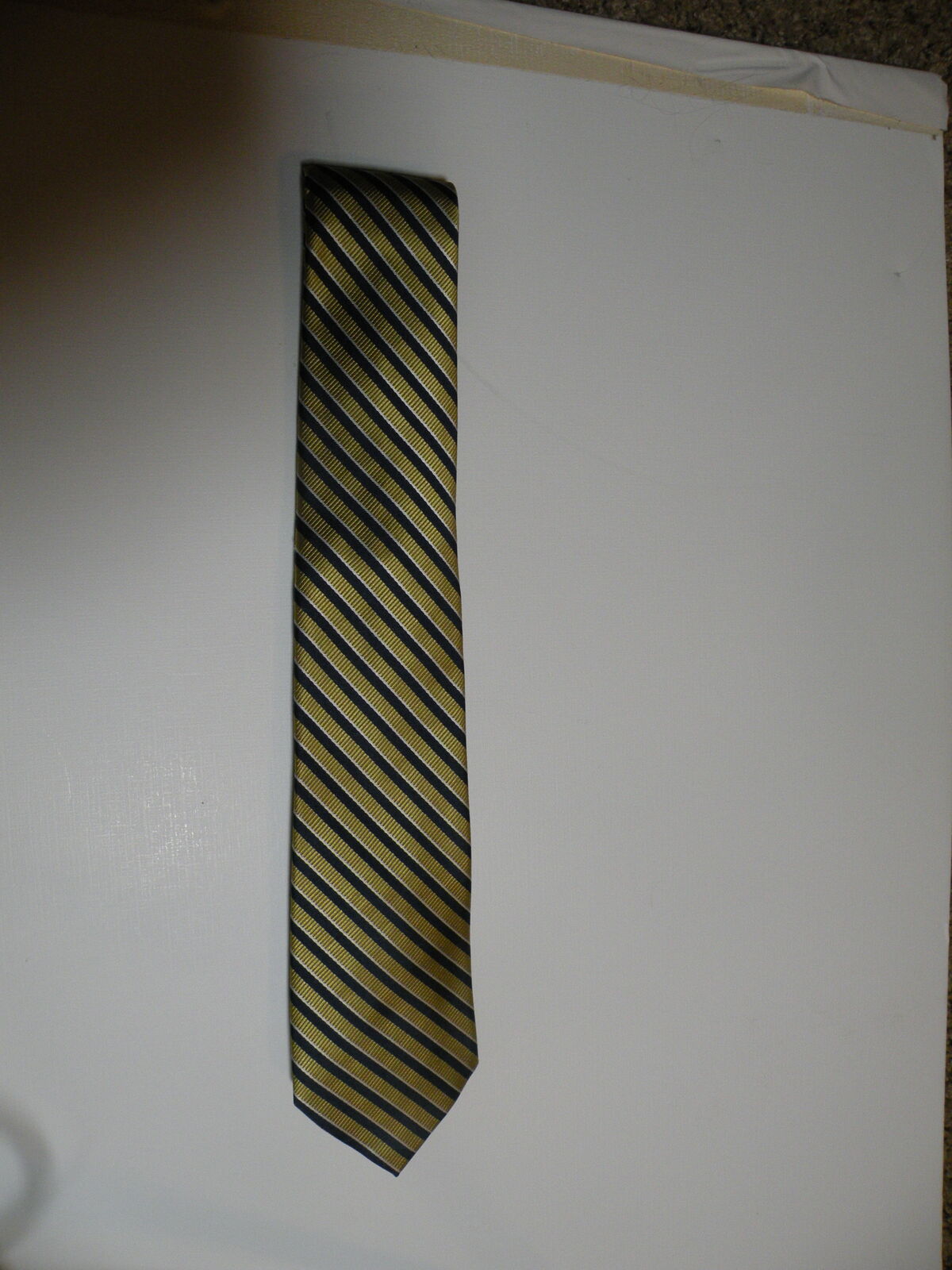 U.S Polo Assn. 100% Polyester Made in China. Tie in Gold, Blue and White.