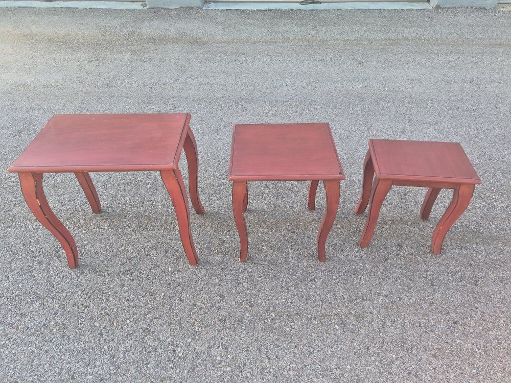 Red-painted wood nesting tables