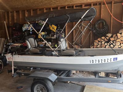 Fishing boat with motor and bimini