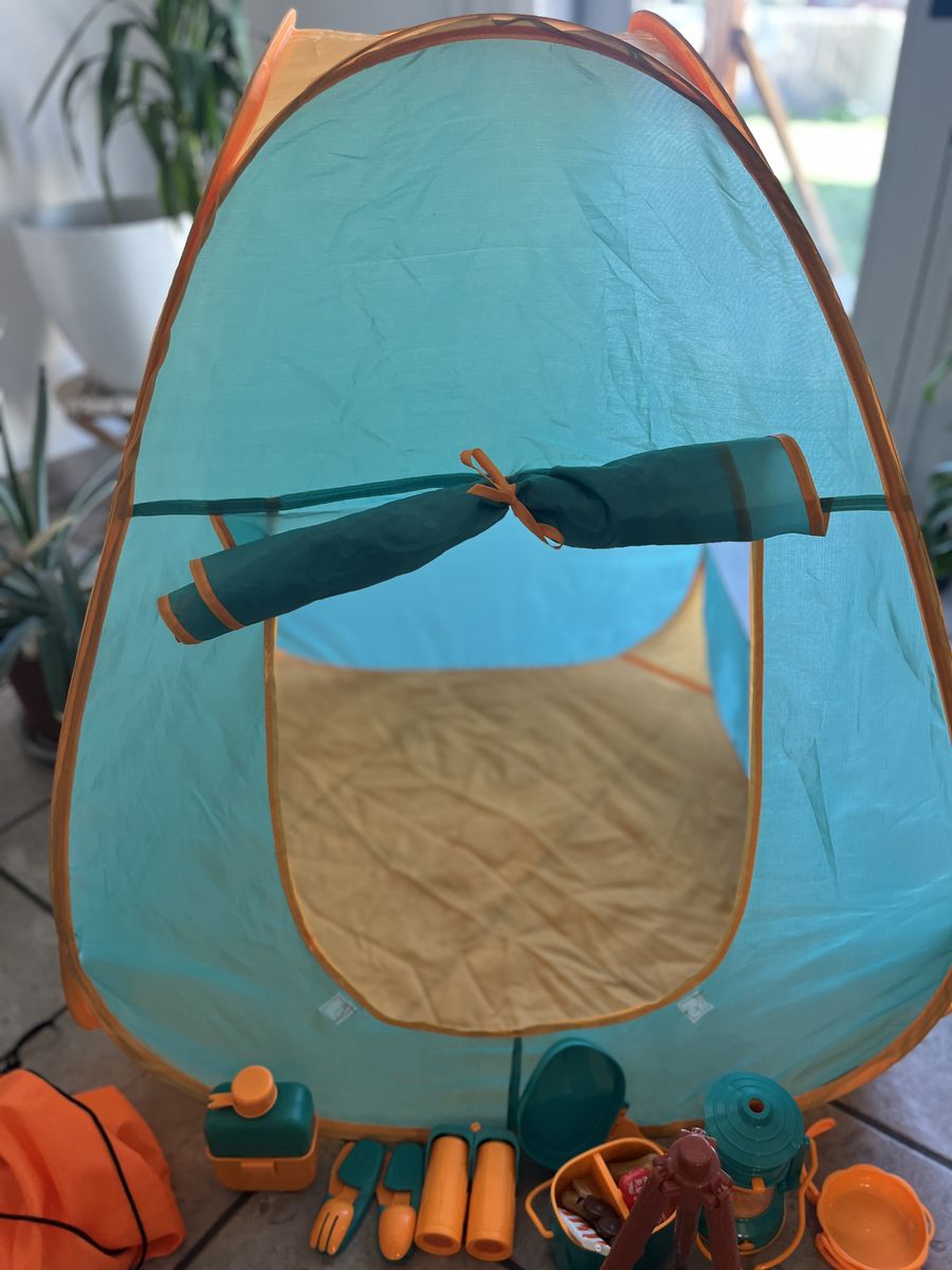 Kids pretend camping setup with tent, lantern, cantine, pretend fire, etc