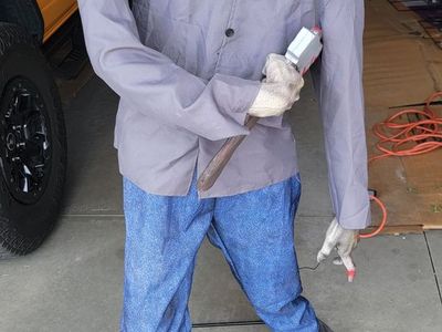 Life-Size Zombie Animatronic Halloween Prop 5'6 ft. Tall, Spooky Decor with Axe and Exposed Arm