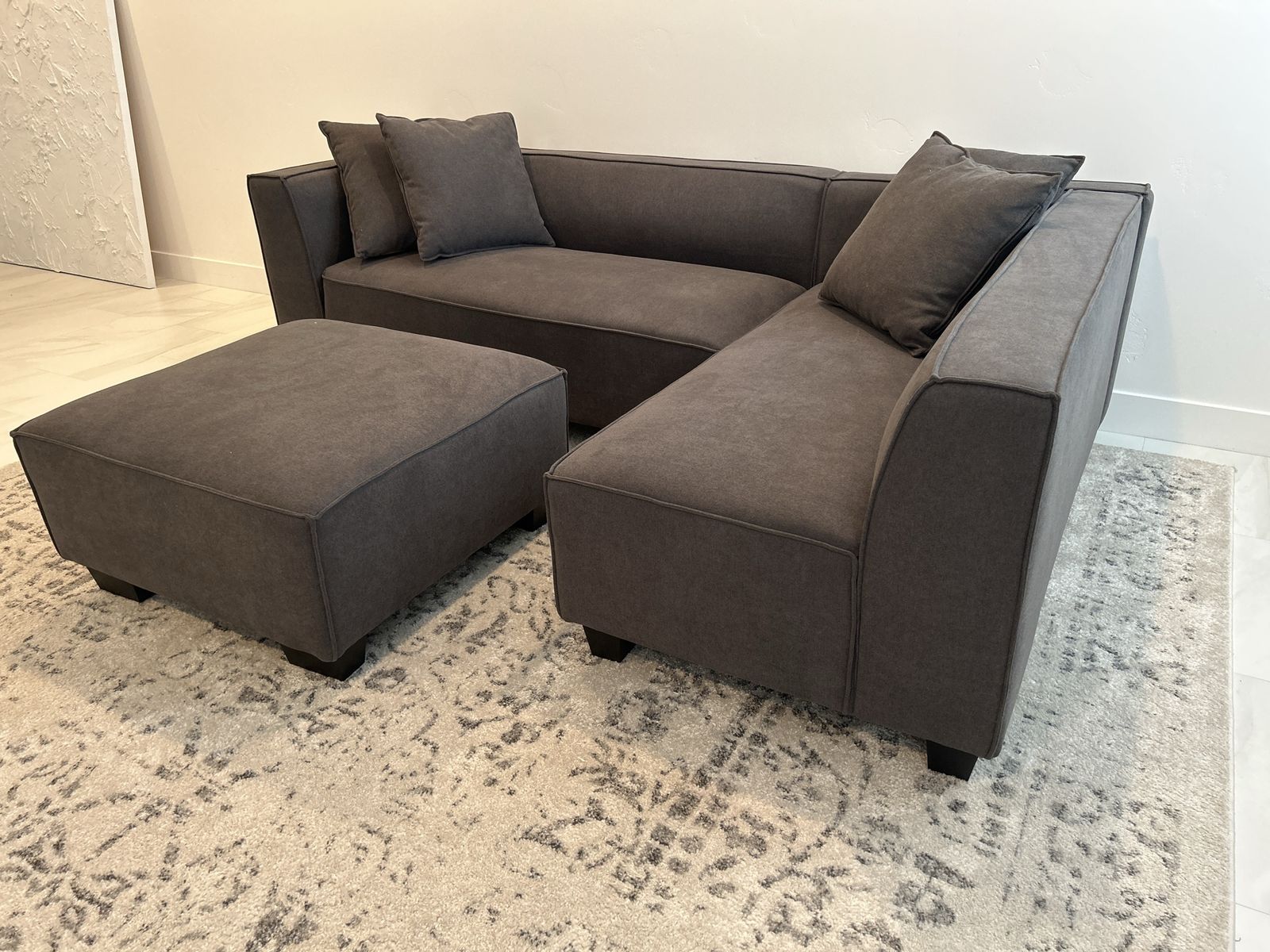 LIKE NEW! Dark Gray Sectional Sofa with Matching Ottoman and Accent Pillows This sectional measures 27.5'' tall by 97.5'' wide,